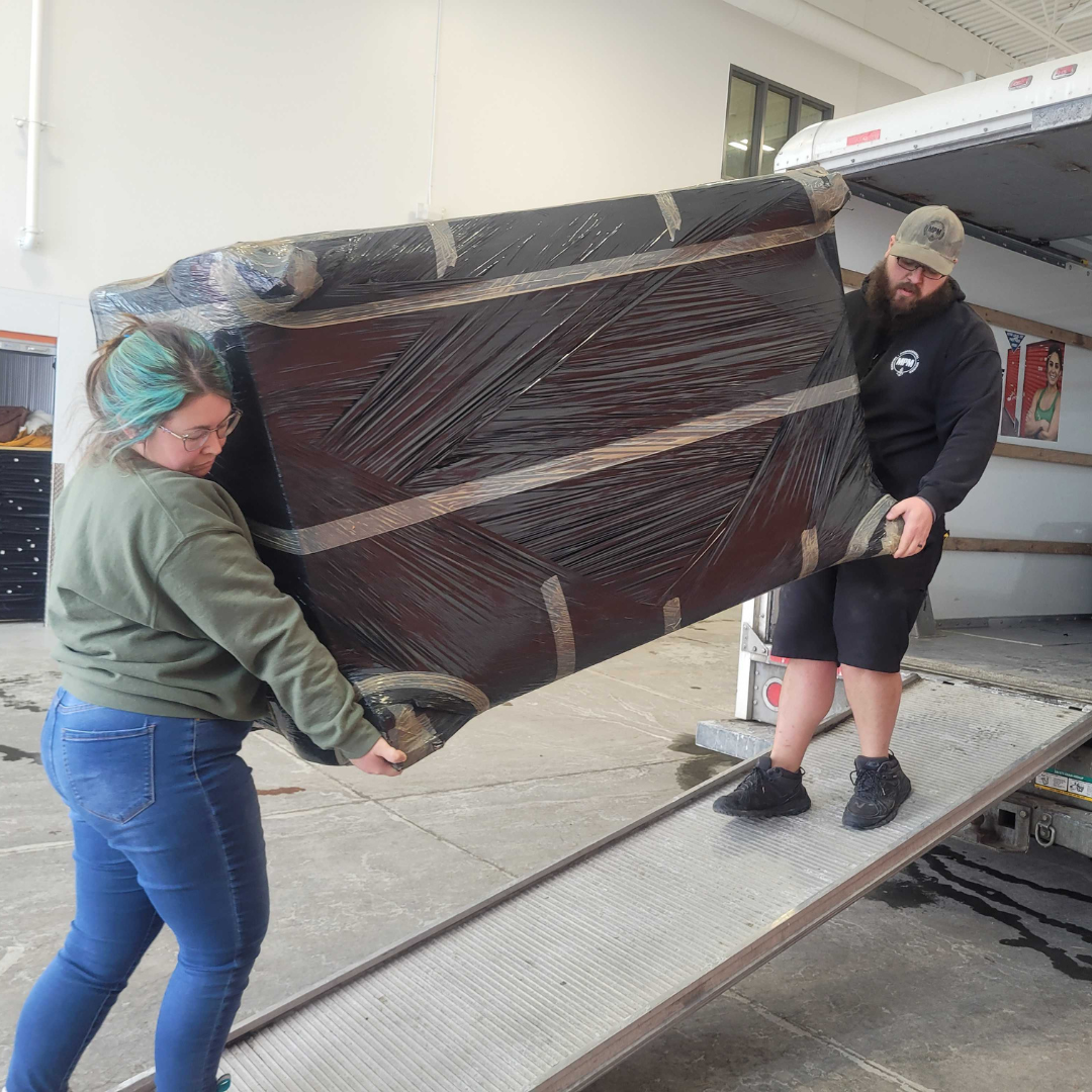 Volunteers lifting couch