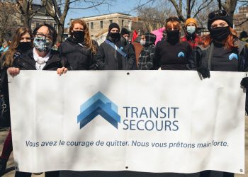 Protest Women holding Transit Secours sign